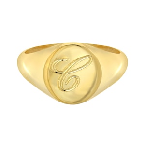 May include: A gold signet ring with a cursive letter "C" engraved on the oval top.
