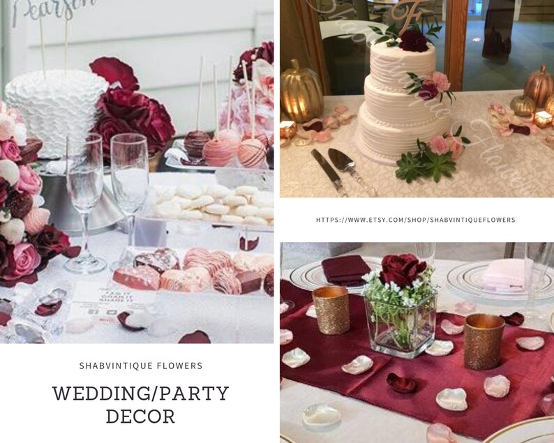 May include: A wedding or party decor table setting with a white cake decorated with burgundy and pink flowers, a bouquet of burgundy and pink roses, and a centerpiece with a single burgundy rose in a glass vase. The table is decorated with burgundy and pink rose petals.