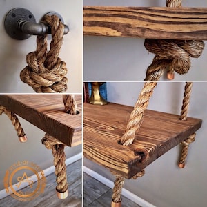 Puede incluir: Una estanter&iacute;a colgante con una tabla de madera te&ntilde;ida de marr&oacute;n oscuro, suspendida por una cuerda de yute trenzada de color natural. La cuerda se fija a la pared con un accesorio de tuber&iacute;a de metal negro y tiene tapas de color cobre.
