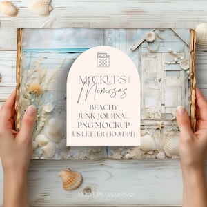 May include: A white book with a rustic wooden cover is open to reveal a beach scene and a decorative wooden house. The book is surrounded by seashells and is being held by a person's hands. The text on the book reads "Mockups and Mimosas, Beachy Junk Journal, PNG Mockup, US Letter (300 DPI)"