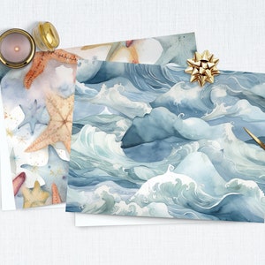 May include: Two sheets of wrapping paper with different designs. One sheet features a blue and white watercolor pattern of ocean waves. The other sheet features a pattern of starfish and seashells in shades of orange, brown, and blue.