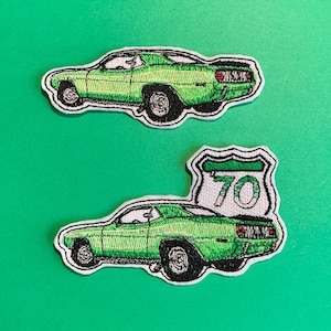 May include: A white ceramic mug with a black handle and the text "But First, Coffee" in a handwritten style. The mug is on a white surface. The mug is 10 cm tall.