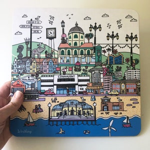 May include: A colorful illustration of the town of Worthing, England. The illustration features a variety of buildings, including a pier, a clock tower, and a tea room. There are also people, animals, and plants in the illustration. The text "Worthing" is at the bottom of the illustration.