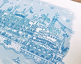 May include: A blue and white illustration of the Brighton Palace Pier in Brighton, England. The illustration features a carousel, a Ferris wheel, a pier, and the text "Brighton Palace Pier" and "Fish & Chips".