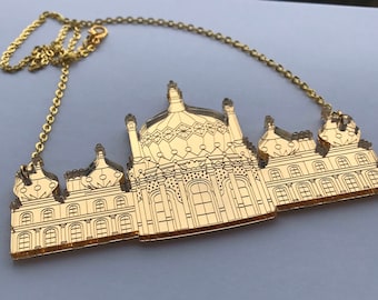 May include: Gold necklace with a mirrored acrylic pendant shaped like the Brighton Pavilion, a famous landmark in Brighton.