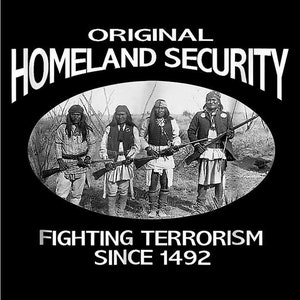 May include: Black and white photo of four people holding rifles. The photo is in a circle with the text "ORIGINAL HOMELAND SECURITY FIGHTING TERRORISM SINCE 1492" around it.