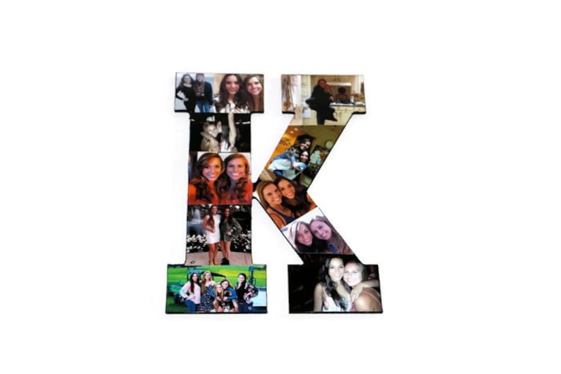 May include: A wooden letter K decorated with a collage of photos. The photos are of people, mostly women, and some are in groups. The letter is painted black and the photos are arranged in a grid pattern.
