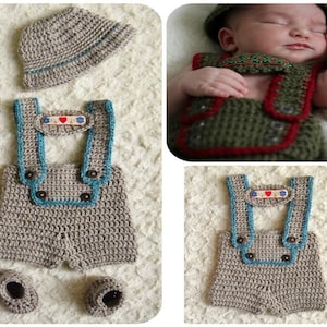 May include: A crocheted baby outfit in beige with blue trim, featuring overalls, a hat, and booties. The overalls have a small heart-shaped patch with the text "I love you" on the front.
