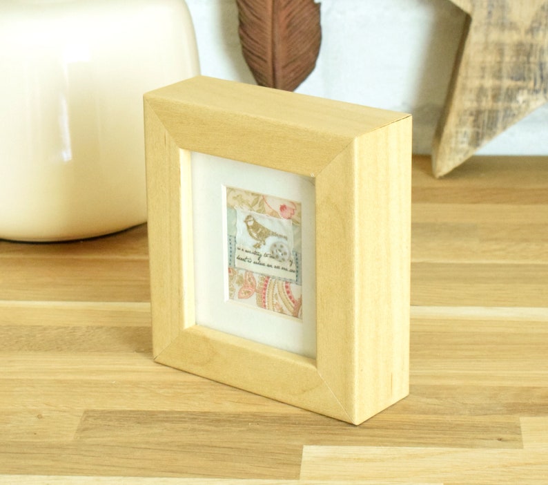 and finished with a tiny spotted button Small vintage style framed fabric collage featuring a tiny bird motif