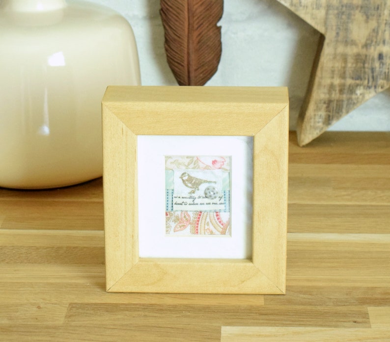 and finished with a tiny spotted button Small vintage style framed fabric collage featuring a tiny bird motif