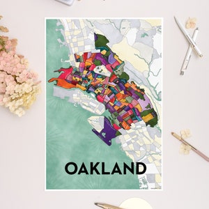 May include: A colorful map of Oakland, California, with the city name printed in black at the bottom. The map is drawn in a watercolor style with a green background.