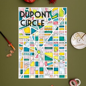 May include: A colorful hand-drawn map of Dupont Circle in Washington, D.C. The map features street names and landmarks in a variety of colors, including green, blue, yellow, pink, and orange.