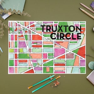 May include: A hand-drawn map of Truxton Circle in Washington, D.C. The map is colorful and features different shades of pink, red, green, and blue. The streets are labeled with their names, including Florida Ave NW, New York Ave NW, and Bates St NW.