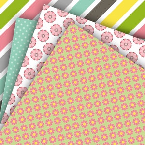 May include: Four different patterned papers with a green, pink, white, and blue color scheme. The papers are arranged in a stack with the top paper featuring a repeating pattern of pink flowers on a light green background.