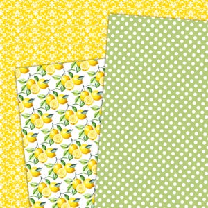 May include: A collection of patterned papers featuring a lemon theme. Designs include a yellow damask pattern, a green polka dot pattern, and a white background with watercolor lemons and green leaves. Ideal for scrapbooking and crafts.
