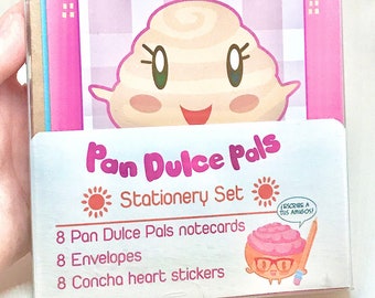 May include: A pink and white stationery set featuring a cartoon character called "Pan Dulce Pals". The set includes 8 notecards, 8 envelopes, and 8 concha heart stickers. The character is a smiling, white, swirl-shaped pastry with brown eyes and a red mouth.