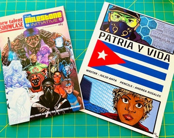 May include: Two comic book covers. The cover on the left is for "The Milestone Initiative: New Talent Showcase" and features a group of superheroes. The cover on the right is for "Patria y Vida" and features a character with a Cuban flag in the background.