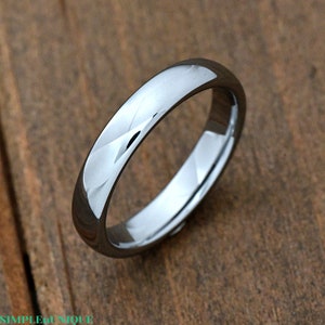 May include: A simple silver-toned wedding band with a brushed finish.