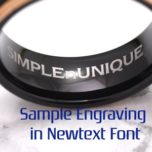 May include: A black tungsten ring with a rose gold inlay and the words "SIMPLE UNIQUE" engraved on the inside of the band. Sample engraving in Newtext font.