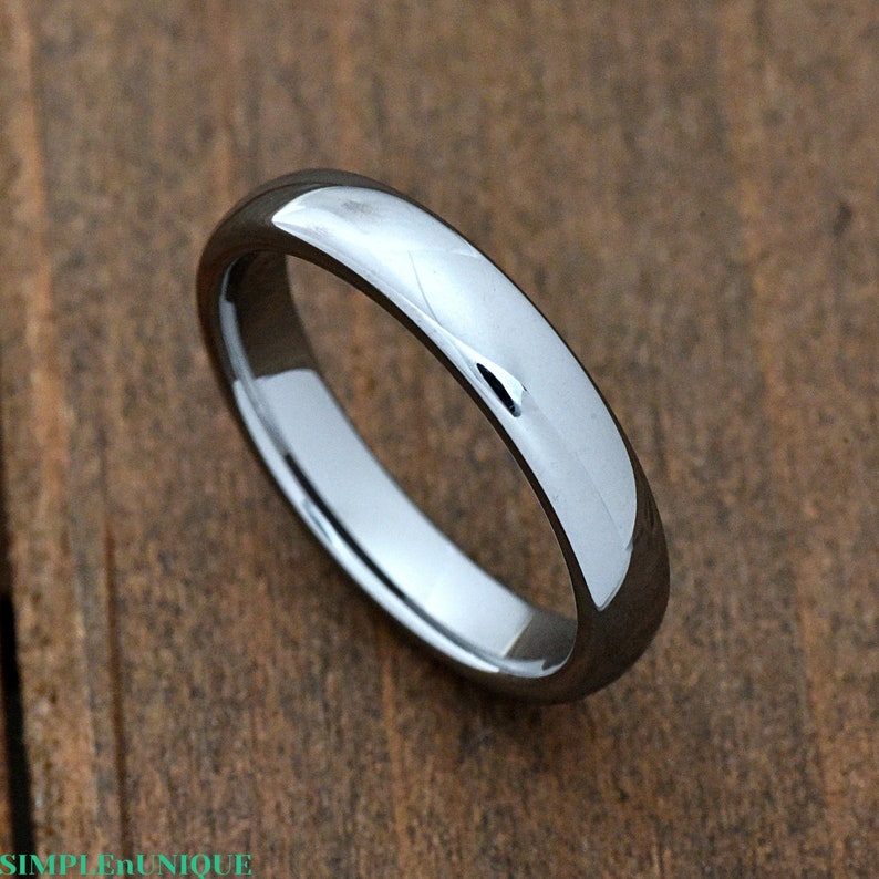 May include: A simple, silver-toned wedding band with a smooth, polished finish.