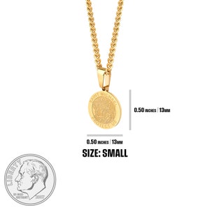 May include: Gold chain necklace with a small, round pendant featuring the image of Saint Michael. The pendant is 0.50 inches in diameter and has the words "Saint Michael Protect Us" inscribed around the edge.