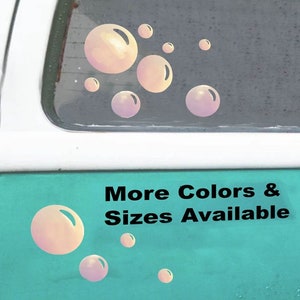 May include: A teal van with a rear window displaying a sticker of iridescent pink bubbles. The text "More Colors & Sizes Available" is printed on the van's side.