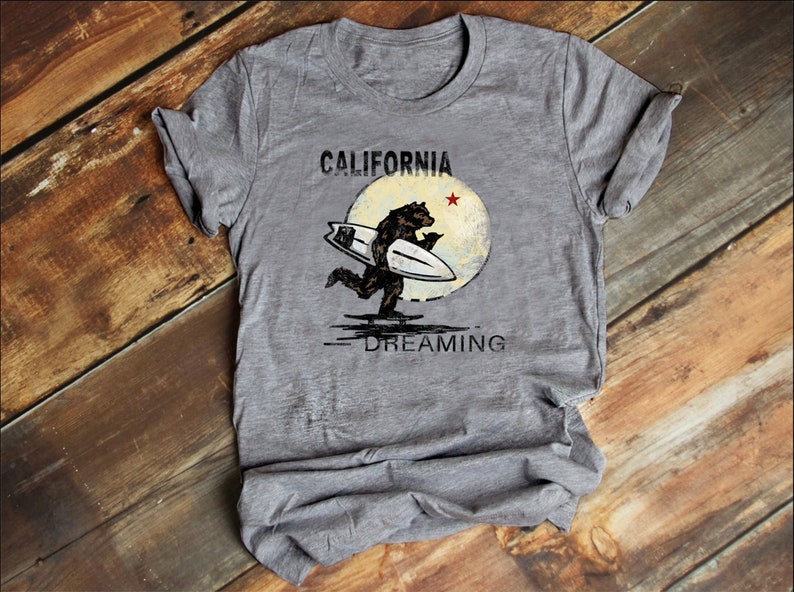 May include: Gray t-shirt with a vintage-style graphic of a bear surfing with the text "CALIFORNIA DREAMING" and a red star.