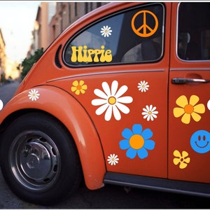 May include: A vintage orange Volkswagen Beetle with a peace sign, flowers, and the word "Hippie" in yellow letters on the side.