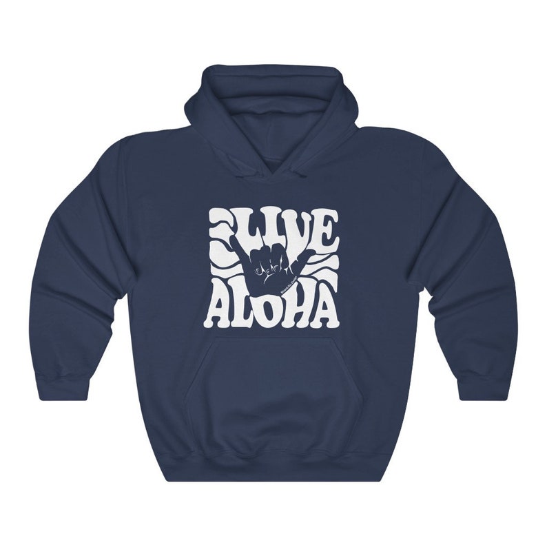 May include: A navy blue hoodie with a white graphic of a hand making the shaka sign with the text "Live Aloha" in a retro font.