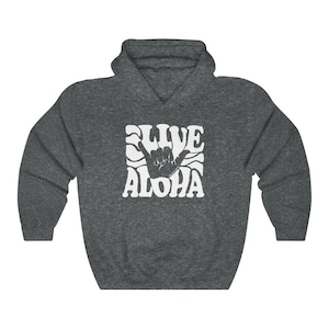 May include: A dark grey hooded sweatshirt with a white graphic print of a hand gesture and the text "LIVE ALOHA" in a retro font.