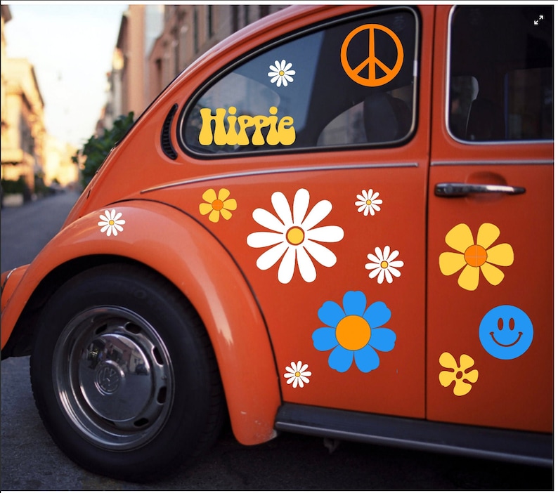 May include: A vintage orange Volkswagen Beetle with a peace sign, flowers, and the word "Hippie" in yellow letters on the side.