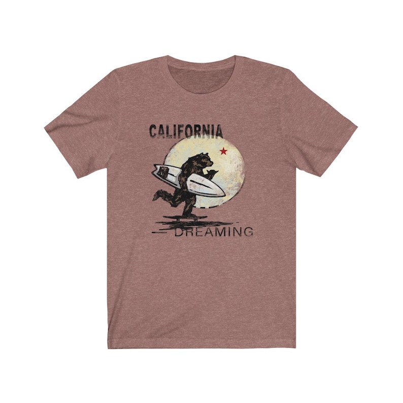 May include: A heather grey t-shirt with a vintage-style graphic of a bear surfing with the text "CALIFORNIA DREAMING" and a red star.