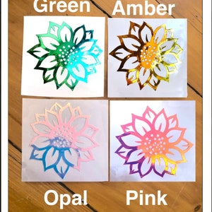 May include: Four holographic sunflower decals in green, amber, opal, and pink. The decals are on white paper with the color names printed below each decal.