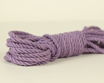 May include: A coil of thick, purple rope. The rope is made of natural fibers and has a soft, textured surface.