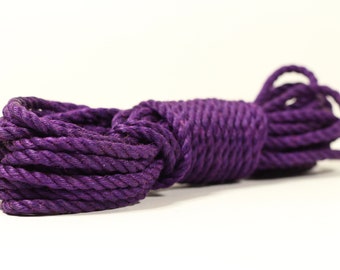 May include: A coil of thick, purple rope. The rope is made of natural fibers and has a rough texture.