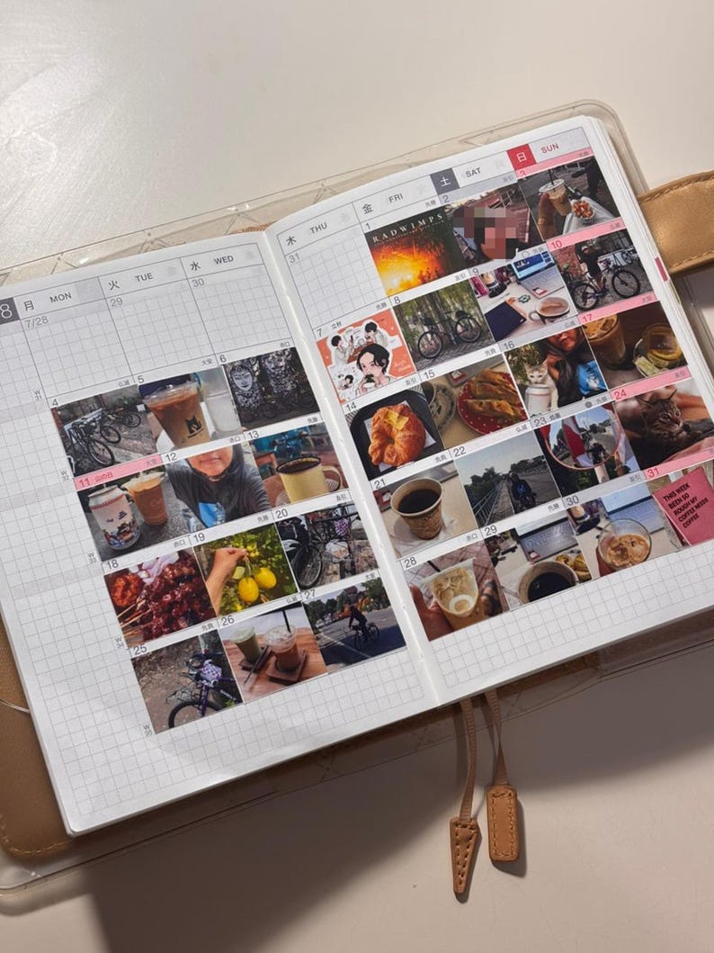 May include: Open planner with a grid layout, featuring a series of small photos and text. The planner is open to a double-page spread, with the left page showing the date 7/28 and the right page showing the date 8/1. The planner has a tan cover.
