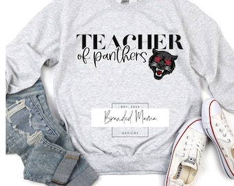 May include: Gray sweatshirt with the text "TEACHER of panthers" and a black panther graphic with red eyes. The text "EST. 2022 Branded Mama DESIGNS" is in a white box below the graphic.