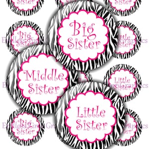 May include: Nine round black and white zebra print stickers with pink borders. Each sticker has a white circle in the center with pink text that reads "Big Sister", "Middle Sister", or "Little Sister".