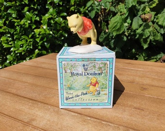 Vintage ceramic Winne the Pooh and the paw marks figurine made by Royal Doulton for Disney.