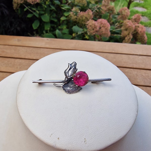 Antique silver pin or brooch with attractive rose and pink stone design.