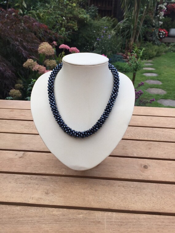 Pretty dark grey necklace made from plastic beads 