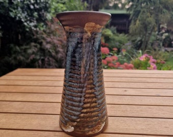 Vintage studio pottery vase in brown and blue with ridged design and irregular pattern.