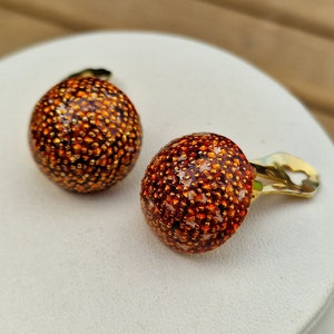 Vintage orange clip earrings with gold metal and mosaic-style design.