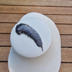 Vintage feather brooch by Sarah Cov made from silver tone metal circa 1960&#39;s.