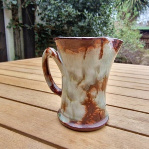 Vintage Ewenny pottery jug, with unusual twisted handle, brown and cream drip glaze design. Made in Wales.