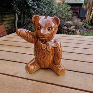 Vintage brown bear with bow tie piggy bank or money box