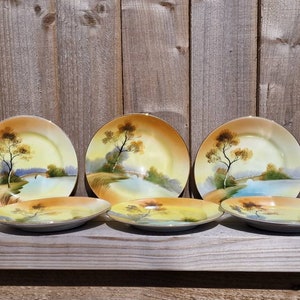 Antique Noritake side plates, six individually available, with tree and sunset design circa 1908. From Japan.