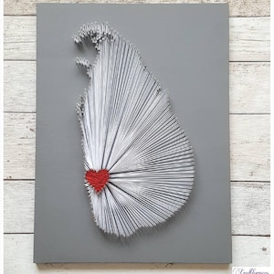 May include: A grey wooden board with a white string art design of the island of Sri Lanka. A red heart is in the centre of the design.