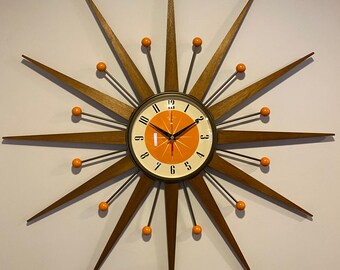 27 inch Hand Made Mid Century style Starburst Clock by Royale Welby style in Antique Bronze with Medium Teak Rays & with Tangerine Dial