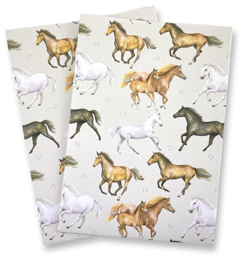 May include: Two sheets of paper with a repeating pattern of running horses in various colors, including white, brown, and black. The horses are depicted in a watercolor style against a light beige background with horseshoe accents.